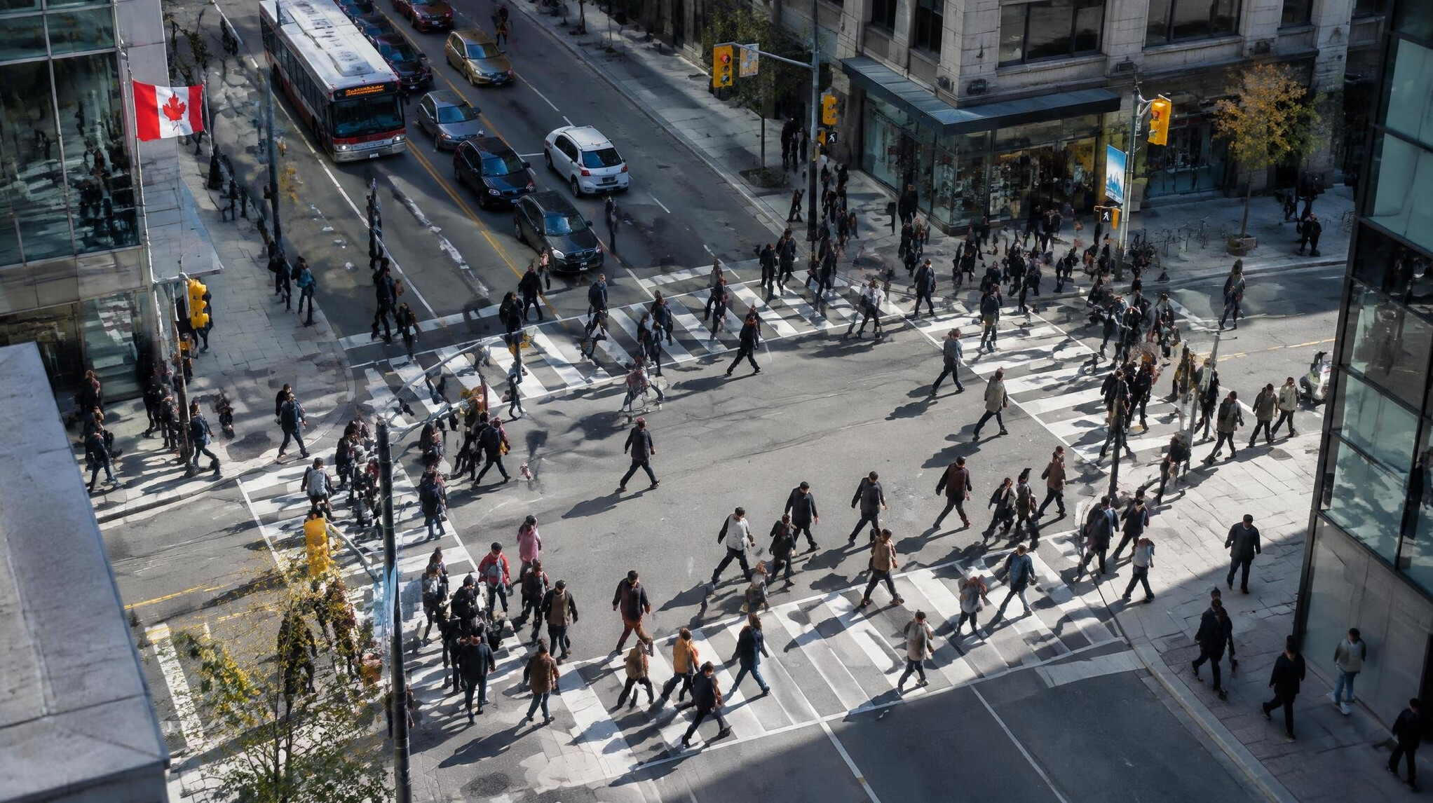 Aerial view of a busy city crosswalk with many pedestrians